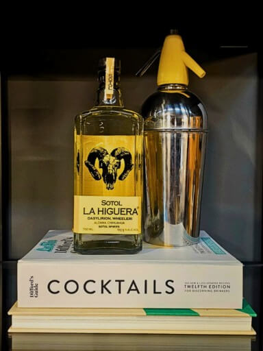 Bottle of Sotol La Higuera Wheeleri 70cl, 43.5%, placed on a cocktail book