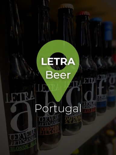 Bottles from the Letra beer range are arranged and lined up on a shelf, displaying colorful and clearly visible labels._1