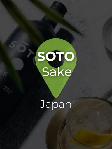Bottle of Sake Soto lying on cement with cocktail next to it, exclusive to the Black Pepper and Basil wine cellar_1